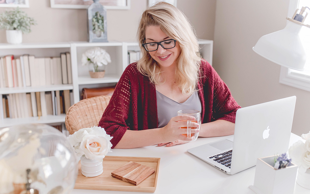 Person working from a home office with a laptop